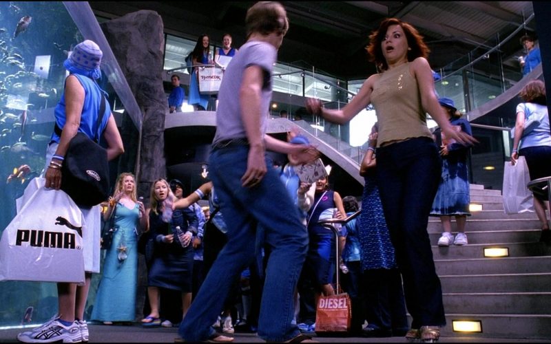 Asics Sneakers, Puma and Diesel Store Bags in Josie and the Pussycats (2001) (Image 1)