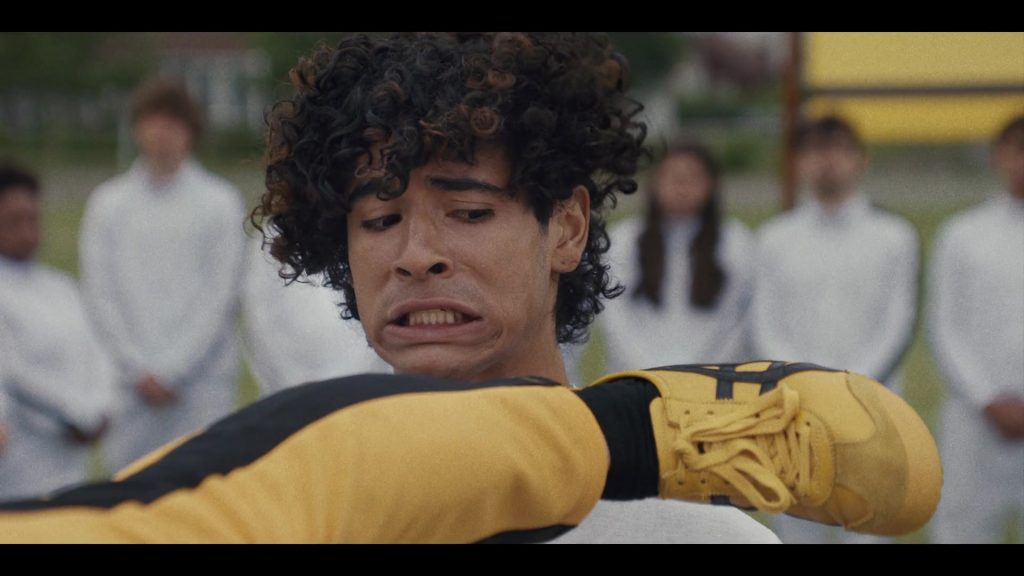 Asics Yellow Sneakers in Miguel Wants to Fight (2023) (Image 1)