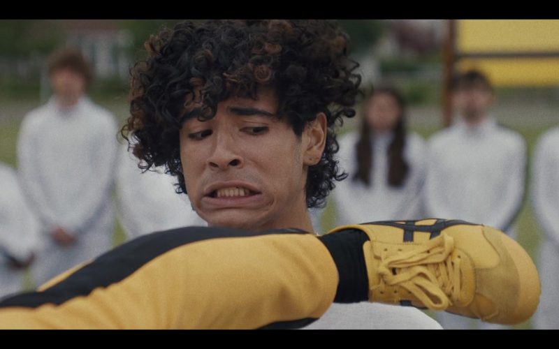 Asics Yellow Sneakers in Miguel Wants to Fight (2023) (Image 1)