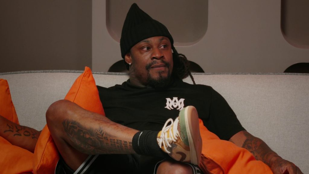 Beast Mode Shorts and Nike Sneakers of Marshawn Lynch in Stars on Mars S01E02 “Water Crisis” (2023) (Image 1)