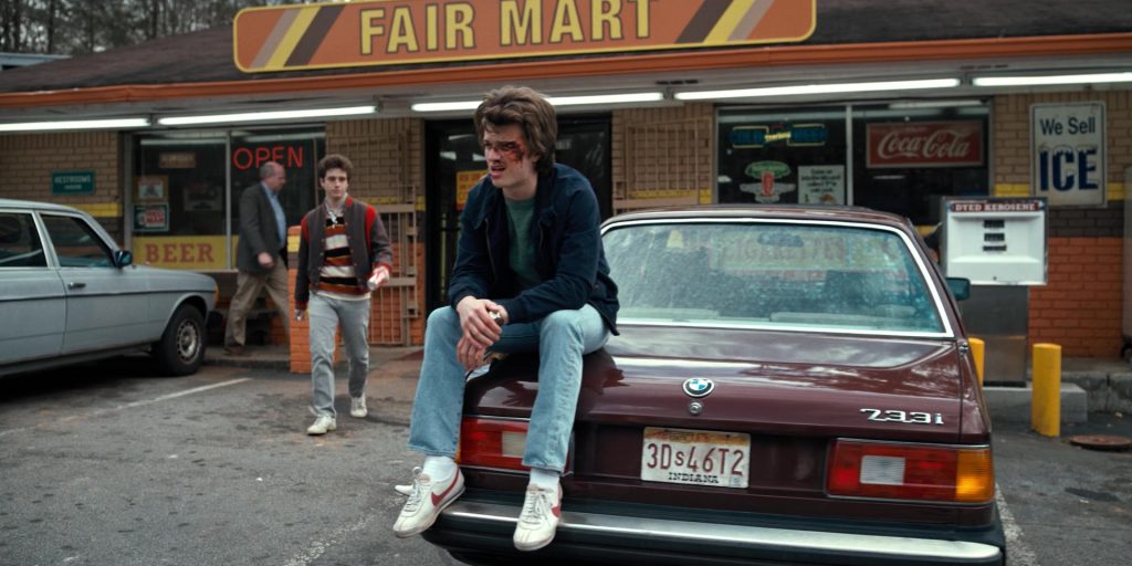 Coca-Cola Signs and Nike Shoes Worn by Joe Keery (Steve Harrington) in Stranger Things - The Bathtub (2016) (Image 1)