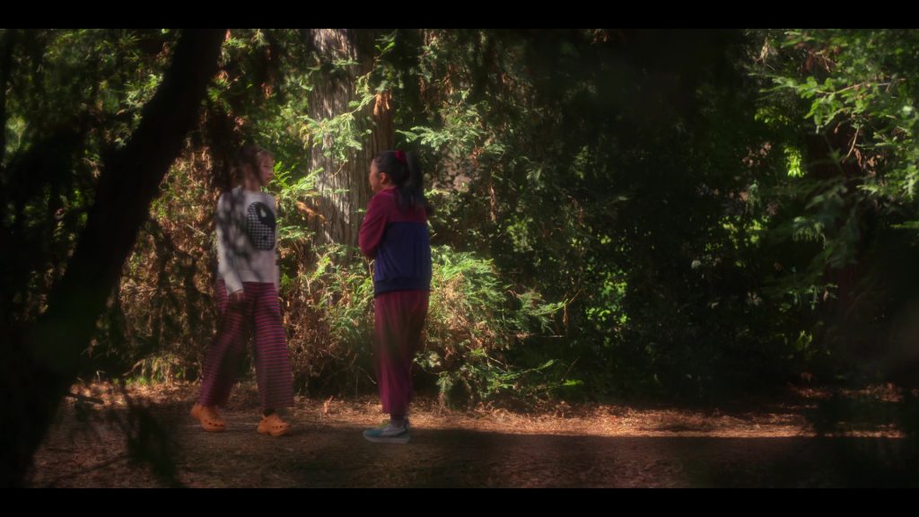 Crocs Orange Platform Heeled Mules of Zoe Colletti as Gia and Reebok Shoes of Lana Condor as Erika in Boo, Bitch S01E01 “Life's a Bitch and Then You Die” (2022) (Image 1)