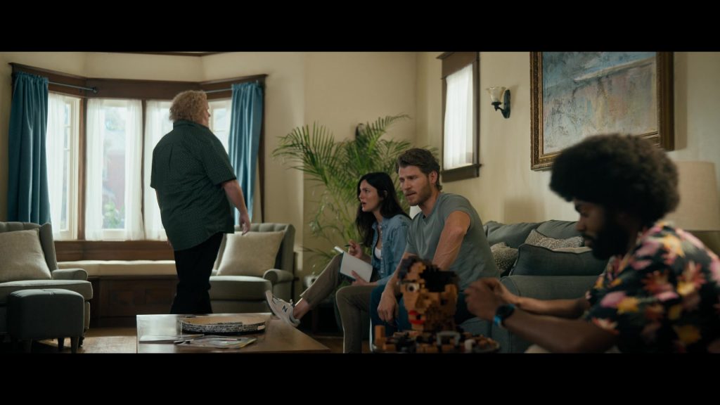 Lego, New Balance Shoes in Fubar S02E01 “Fullest House” (2025) (Image 1)