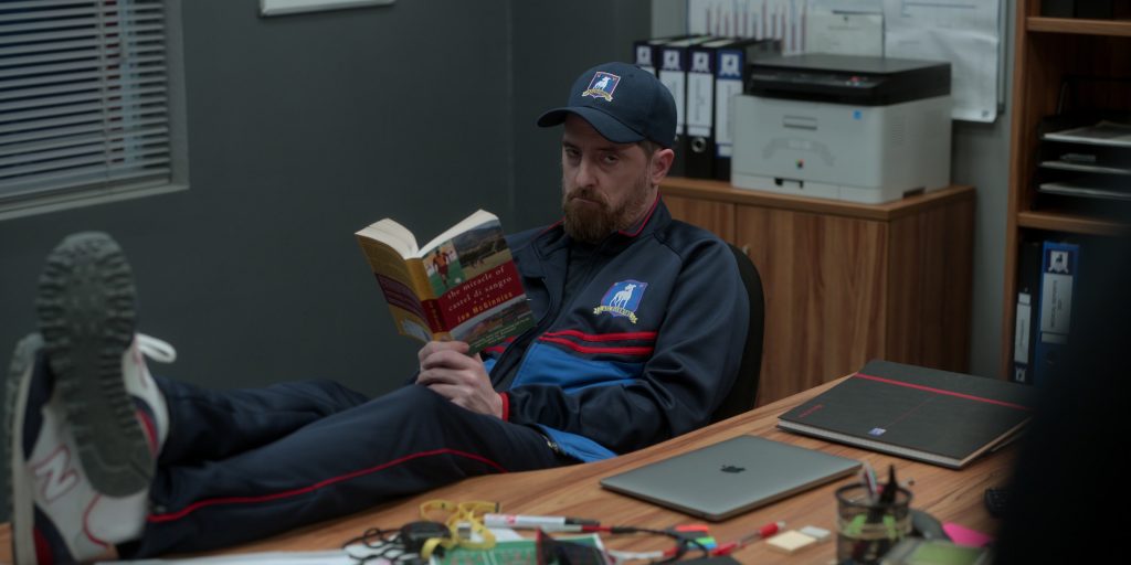 New Balance 515 Sneakers and Apple MacBook Laptop of Brendan Hunt as Coach Beard in Ted Lasso S03E01 “Smells Like Mean Spirit” (2023) (Image 1)