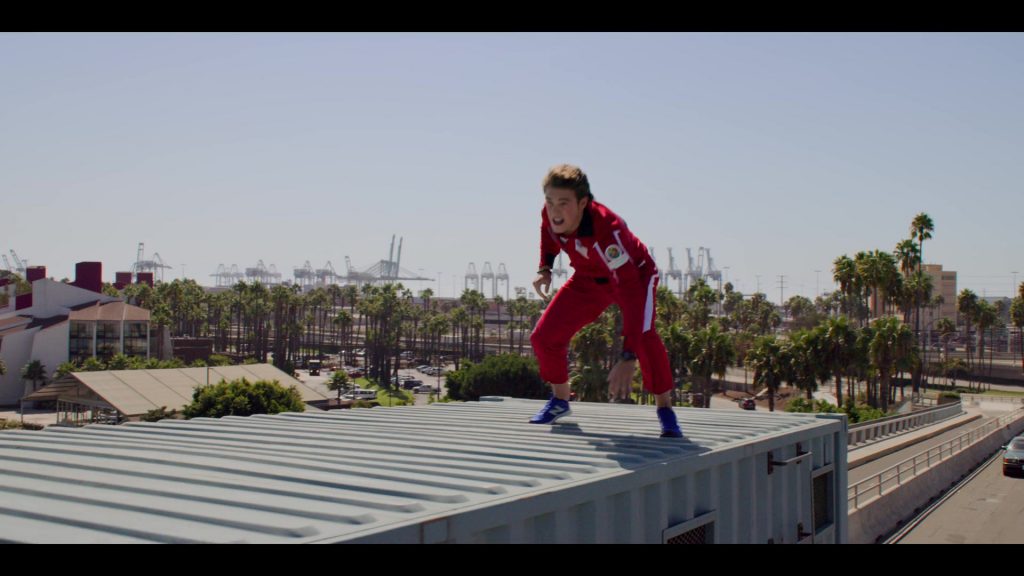 New Balance Blue Sneakers of Ricardo Hurtado as Tyler in Malibu Rescue - The Next Wave (2020) (Image 2)
