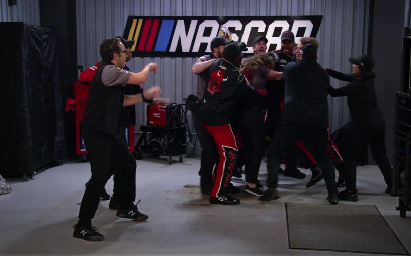 New Balance Men's Sneakers of Dan Ahdoot as Amir and NASCAR Sign in The Crew S01E01 “I Guess That Cake Did Need To Be Refrigerated” (2021) (Image 1)