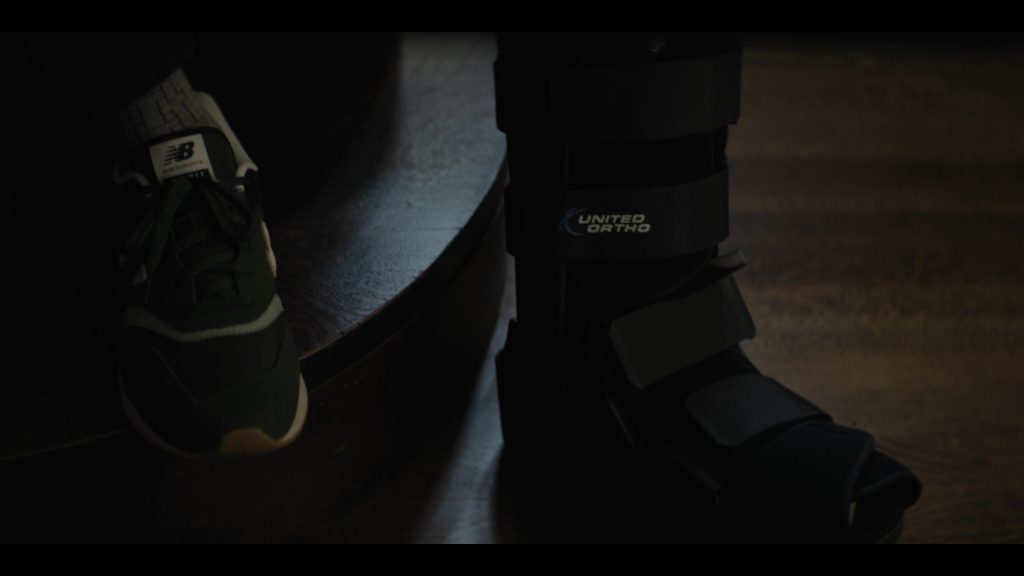 New Balance Shoes and United Ortho in Emperor of Ocean Park S01E10 (2024) (Image 1)