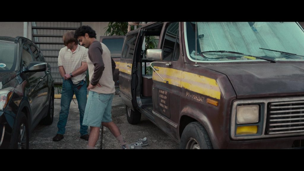 New Balance Sneakers in Hit Man (2023) (Image 1)