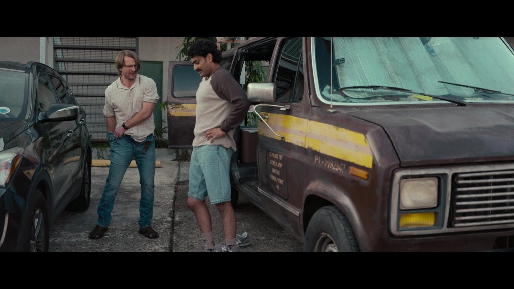 New Balance Sneakers in Hit Man (2023) (Image 2)