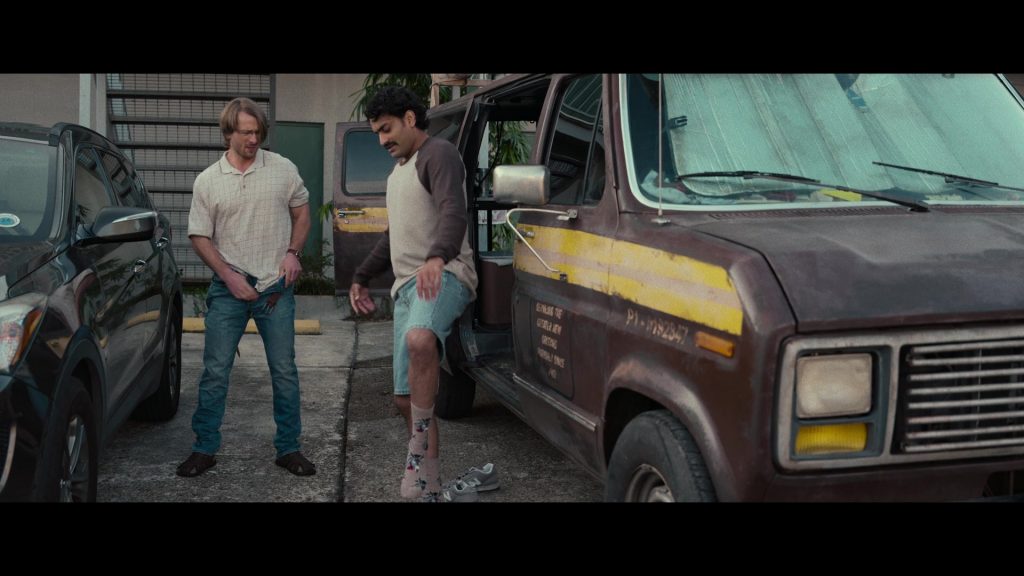 New Balance Sneakers in Hit Man (2023) (Image 3)