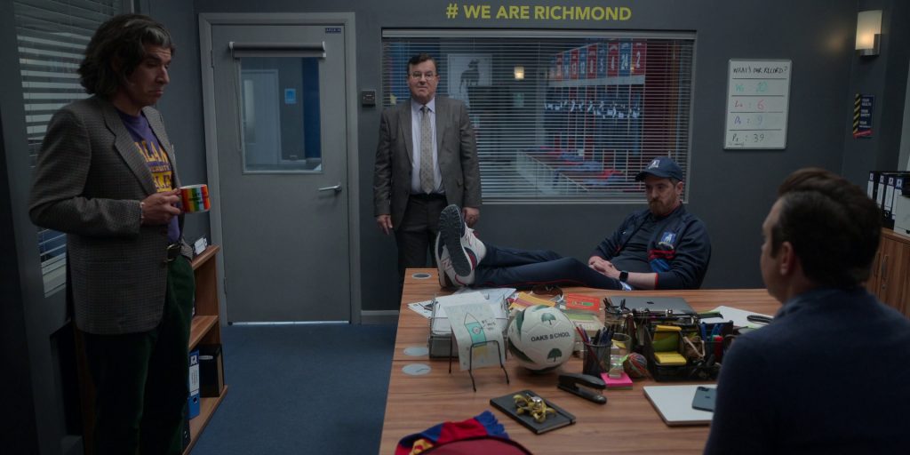 New Balance Sneakers of Brendan Hunt as Coach Beard, Apple MacBook and iPhone in Ted Lasso S03E08 “We'll Never Have Paris” (2023) (Image 1)