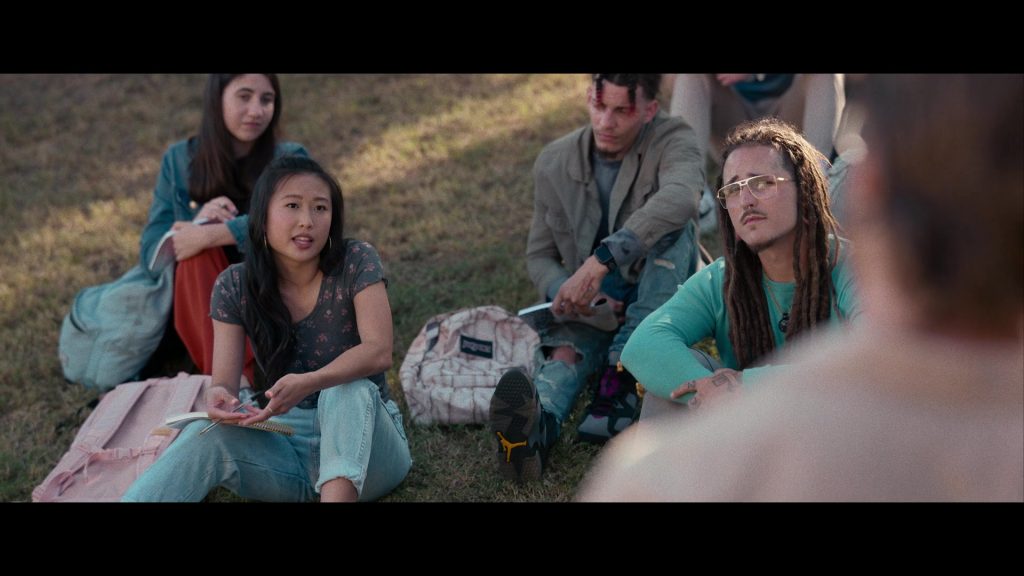 Nike Air Jordan Sneakers and JanSport Backpack in Hit Man (2023) (Image 12)