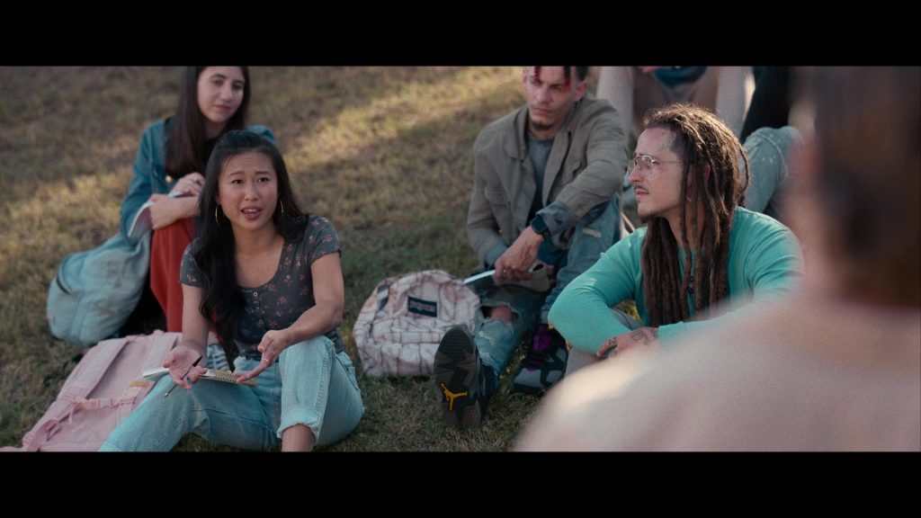Nike Air Jordan Sneakers and JanSport Backpack in Hit Man (2023) (Image 2)