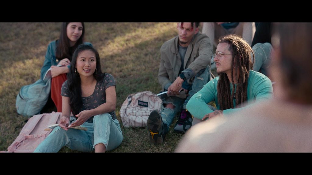 Nike Air Jordan Sneakers and JanSport Backpack in Hit Man (2023) (Image 6)