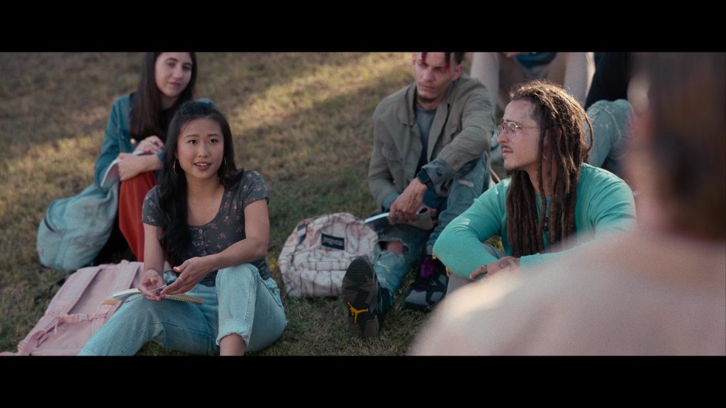 Nike Air Jordan Sneakers and JanSport Backpack in Hit Man (2023) (Image 7)