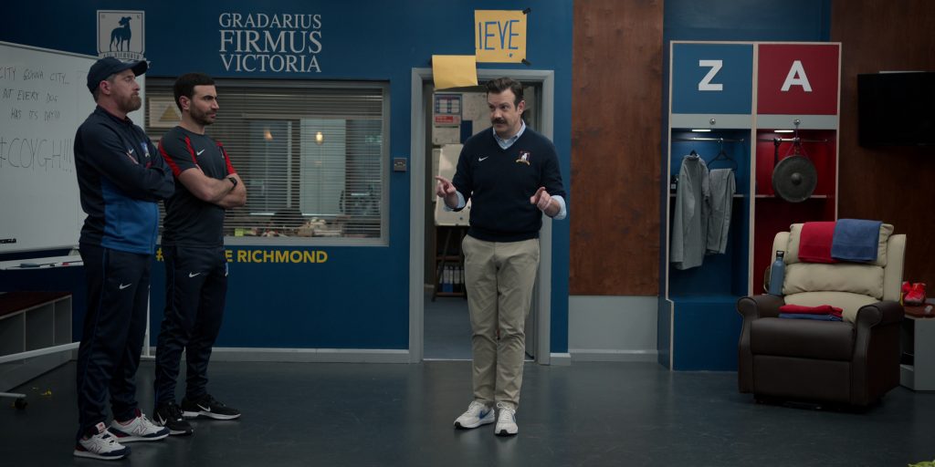 Nike Air Zoom Sneakers of Jason Sudeikis, New Balance Shoes of Brendan Hunt as Coach Beard, Nike Black Sneakers and Clothes of Brett Goldstein as Roy Kent in Ted Lasso S03E05 “Signs” (2023) (Image 1)