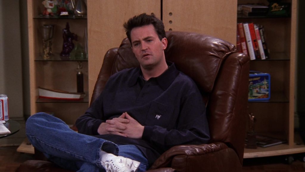 Nike Sneakers and Big Dogs Long Sleeve Shirt Worn by Matthew Perry (Chandler Bing) in Friends Season 5 Episode 12 “The One with Chandler’s Work Laugh” (1999) (Image 1)