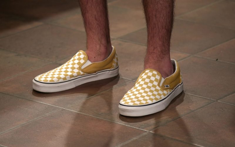 Vans Classic Slip On Checkerboard Ochre & White Shoes of Reed Horstmann as Stick in The Expanding Universe of Ashley Garcia S01E12 “Count Me In” (2020) (Image 1)
